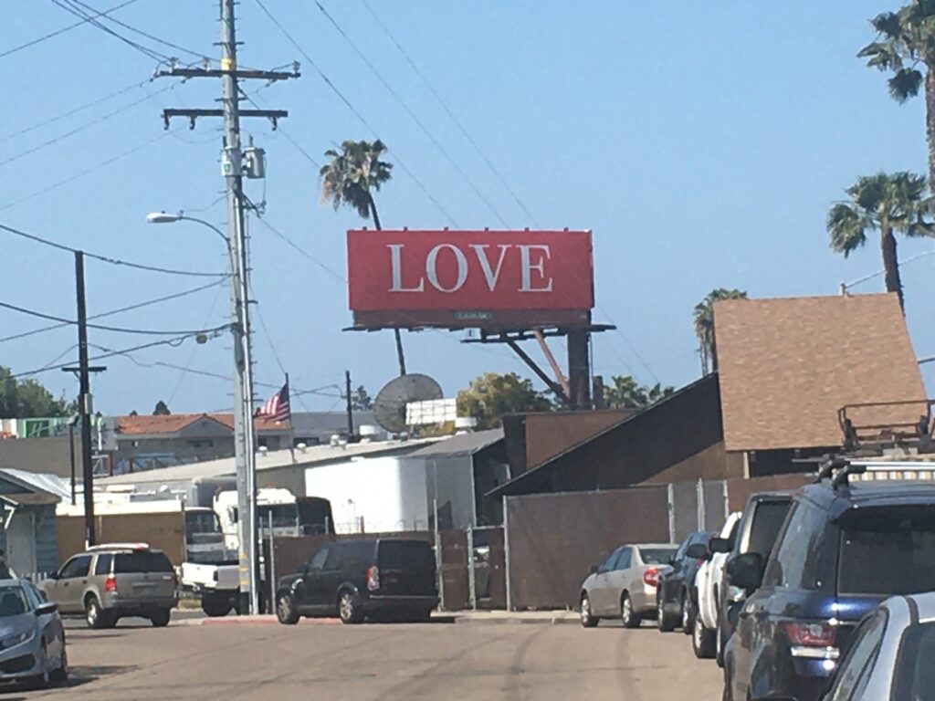 Photo of billboard with the word "LOVE" on it.