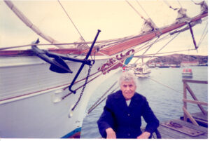 Photo of Aunt Margaret in front of a sail boat.